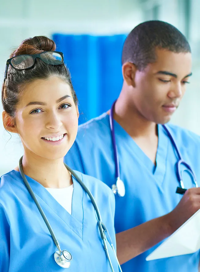 Clinician of the Future 2023 Education Edition - Banner - Two students standing together. One facing the camera and the other looking down at the tablet.