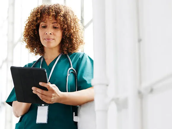 female nurse checking tablet