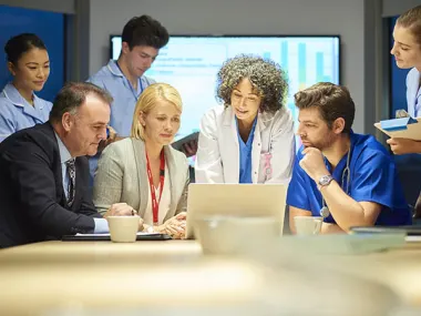 Image depicting a collaboration between business and medical professionals (© Sturti/E+ via Getty Images)