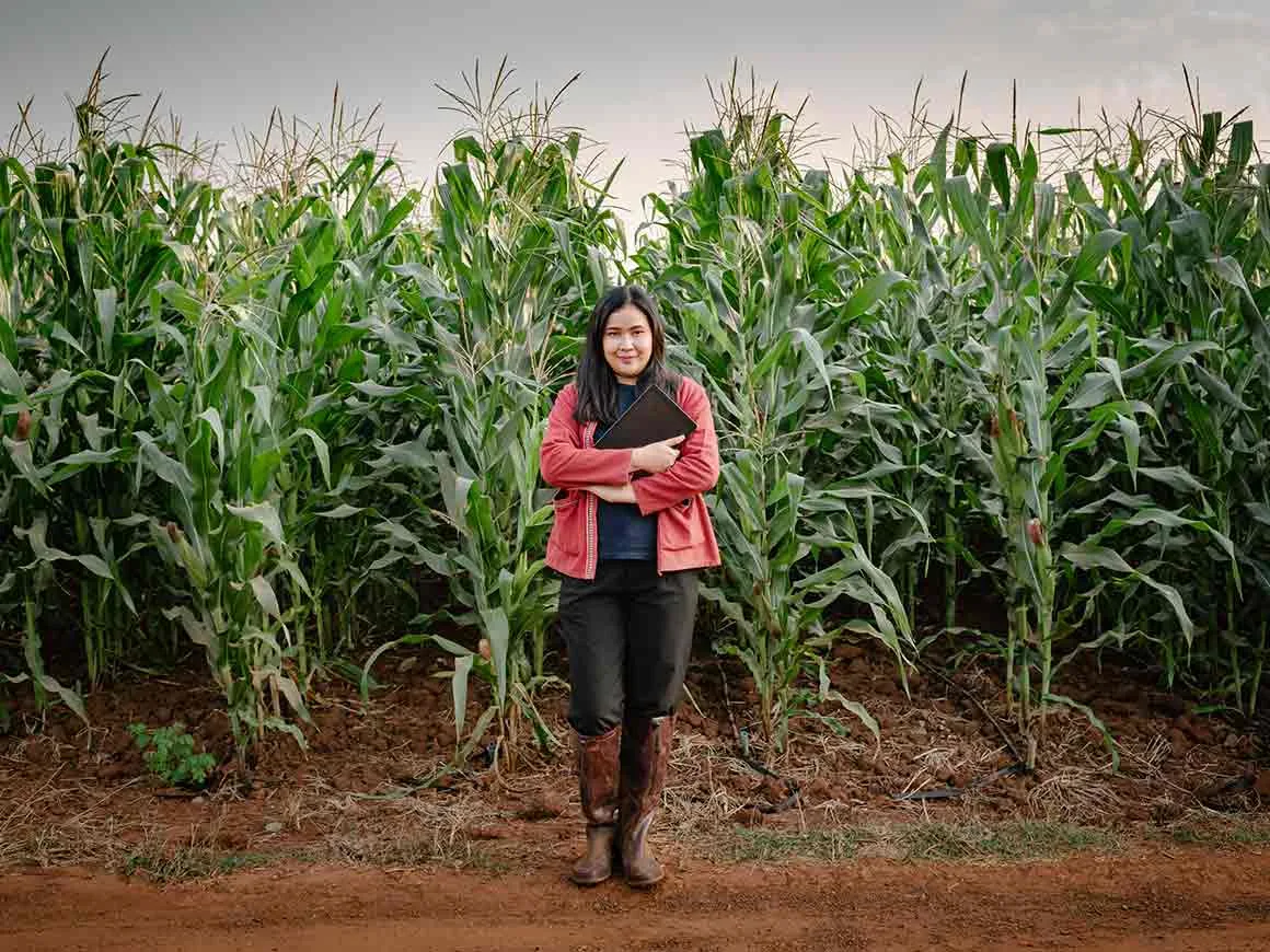 Portrait of Woman Farmer With Digital Tablet While Observing Plant Disease Research at Corn Field