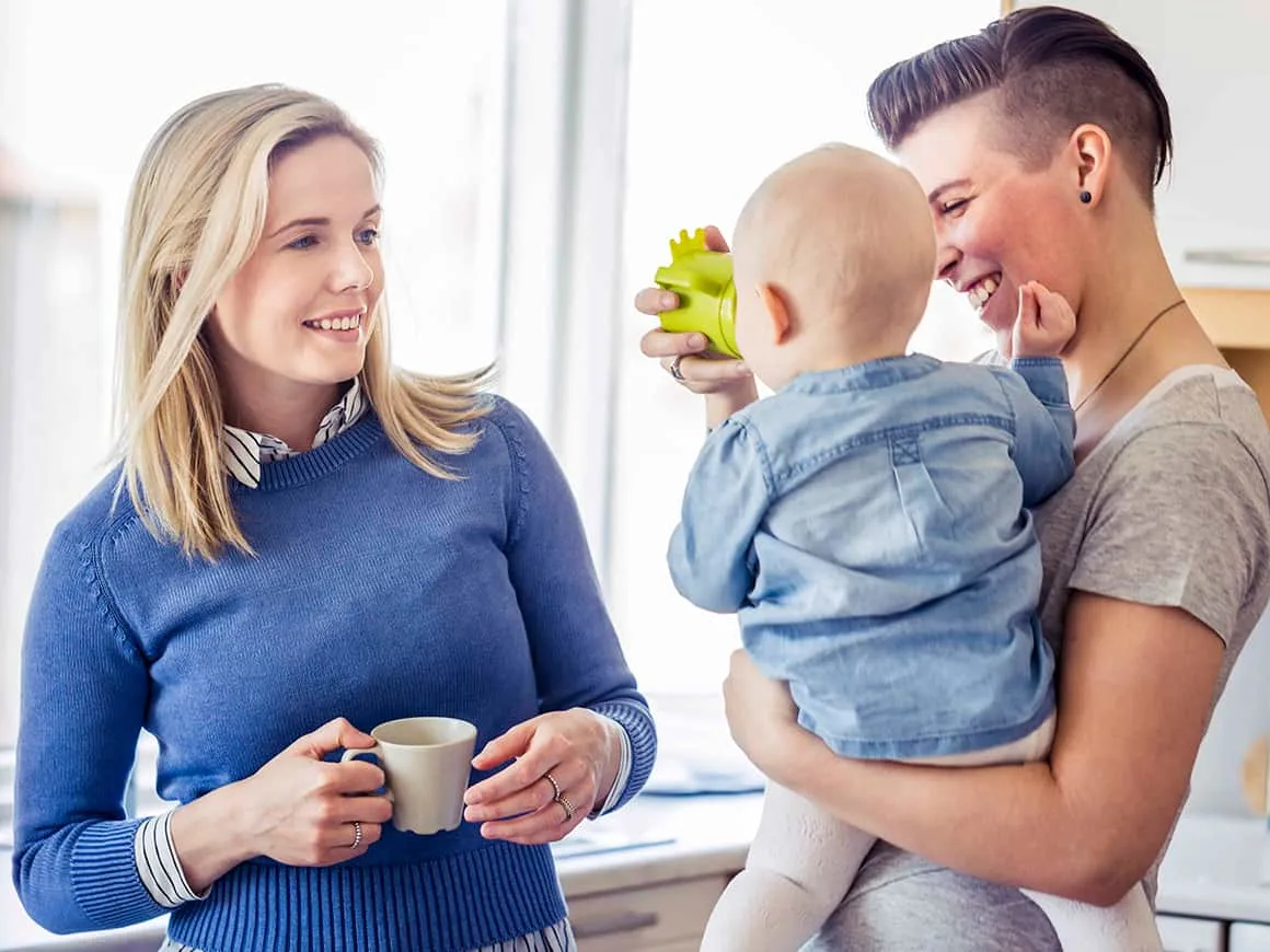 woman looking at partner feeding baby