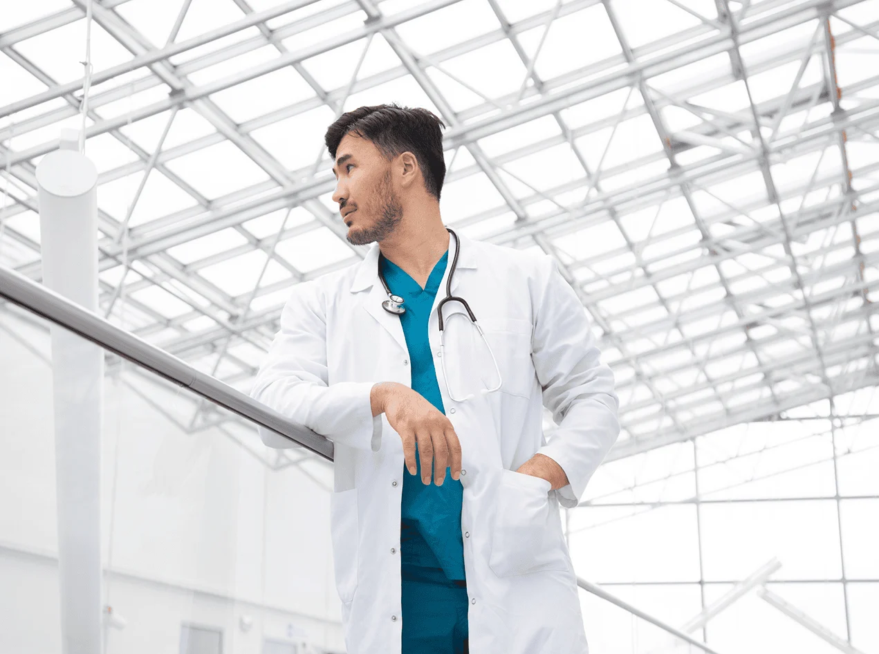 Pensive doctor looking over hospital